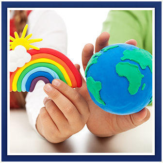 Children's hands hold clay rainbow and globe figures