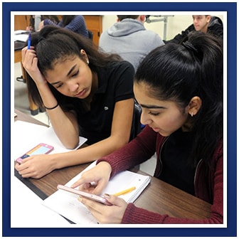 Two students look at a smartphone together