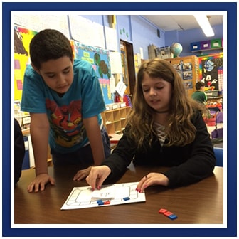 Two students work on an assignment together in class