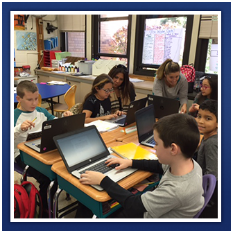 Students use laptops in class