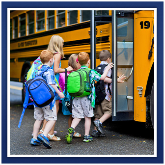 students getting on a bus