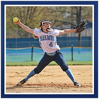 Female student plays softball on a field