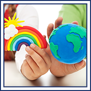 Children's hands hold clay rainbow and globe figures