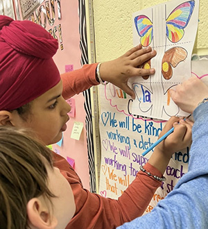 Students tracing out their paper butterflies
