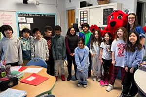 students and staff standing around Clifford