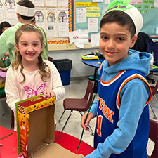 Fourth grader helping a first grader build a leprechaun trap