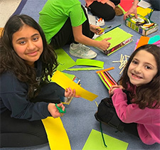 First and fourth graders building leprechaun traps
