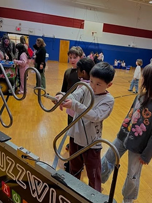 Students playing with a pipe display
