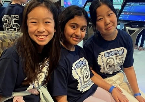 Three girls smiling for the camera