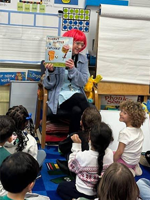 Teacher holding a book up to students