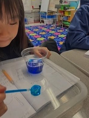 Student creating a blue dot