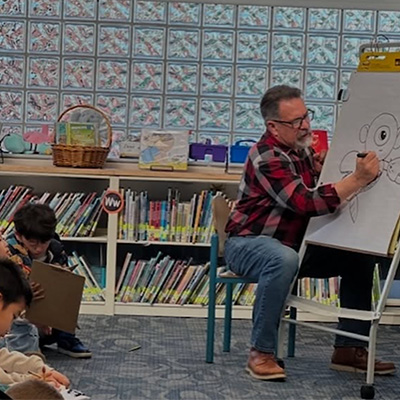 Author drawing an alien