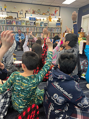 students raising their hands