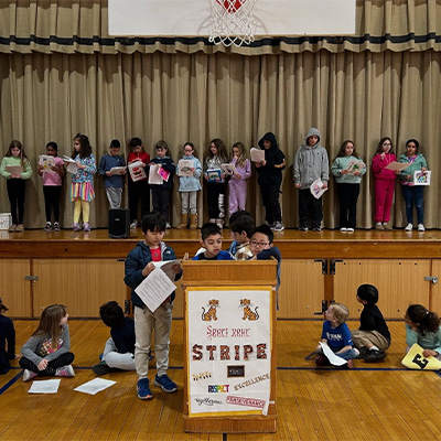 students on stage with awards