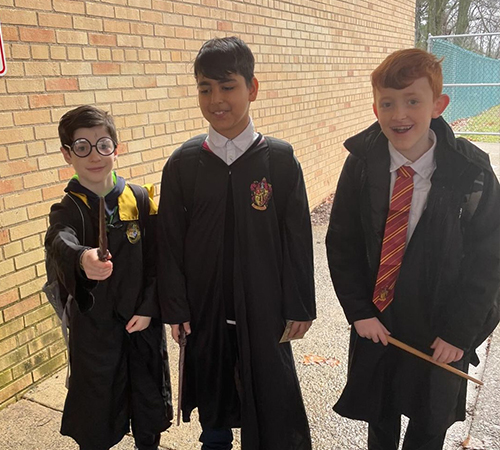 Three students dressed in character outside