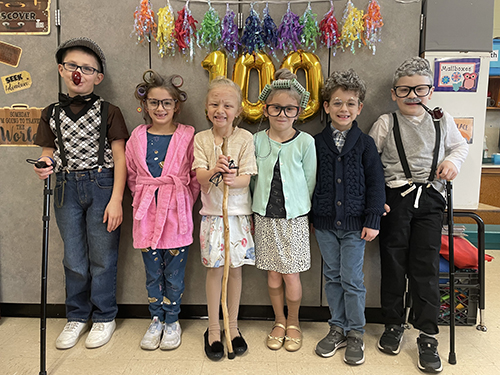 Happy first grade students dressed up to celebrate 100 days of school